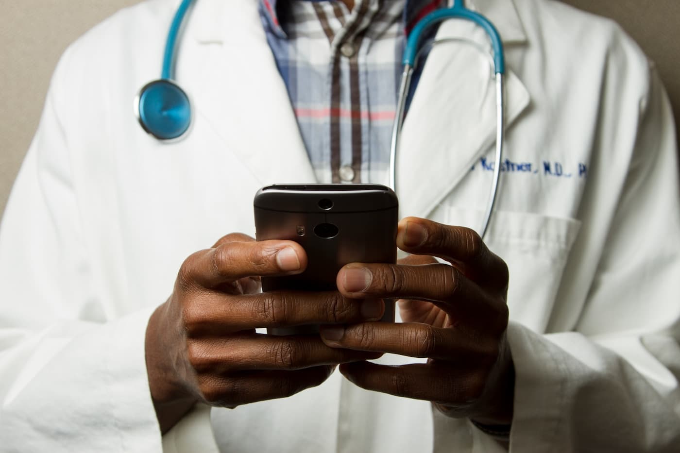 A clinical professional reviewing patient data — representing the HIPAA-aligned healthcare AI Aiinfox builds for hospitals, clinics, and medtech operators.