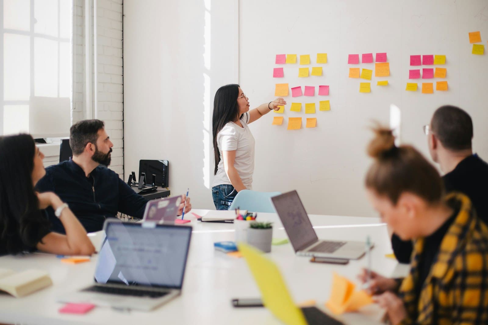 A Cardiff-based product team in a working session — Aiinfox's senior UK delivery for Admiral-adjacent insurance fintech, BBC Wales-adjacent media, Welsh Government public sector, and Cardiff gaming studios.
